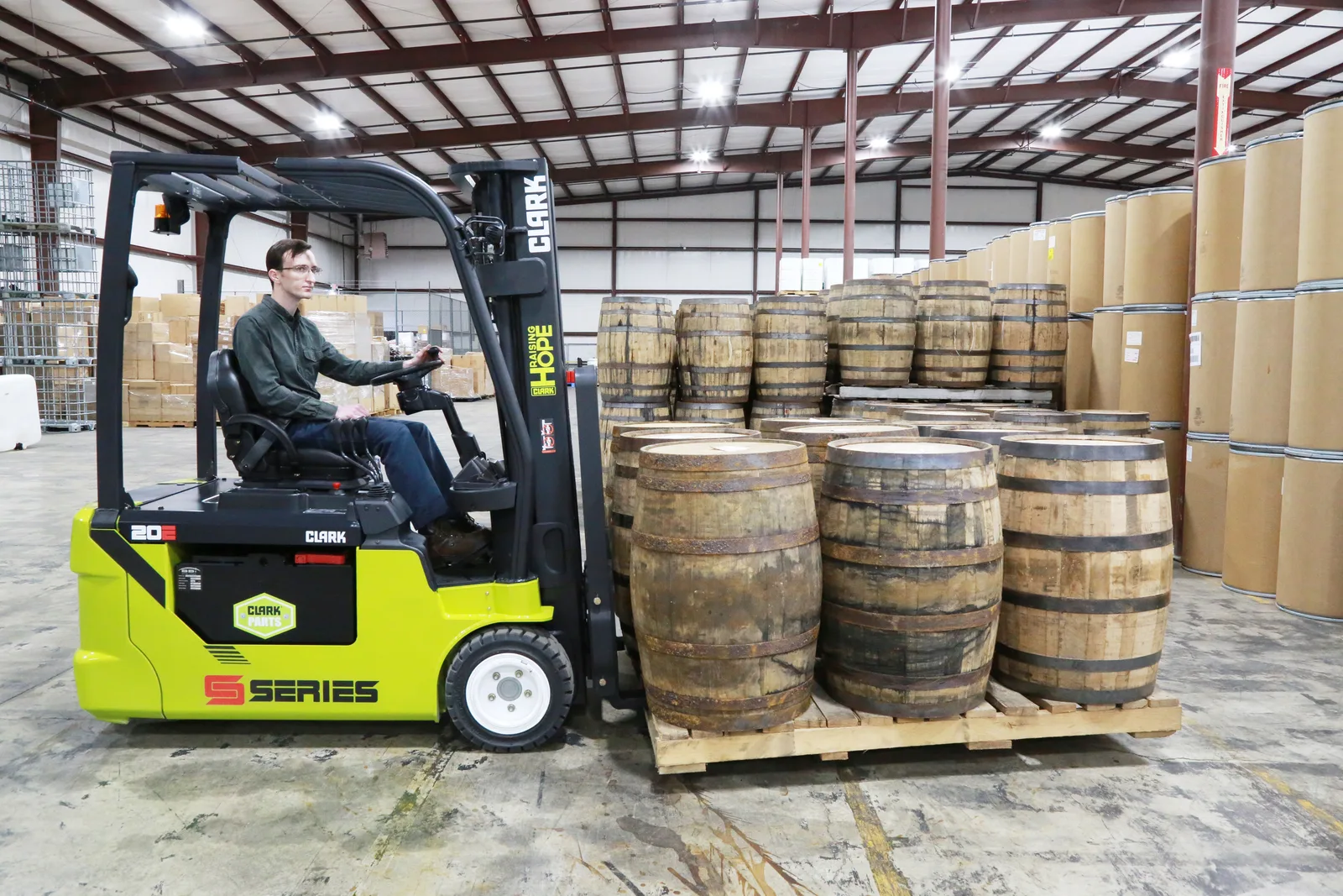 Clark S-Series electric forklift moving barrels in a Delaware warehouse